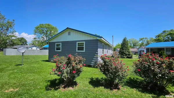 a front view of house with a garden