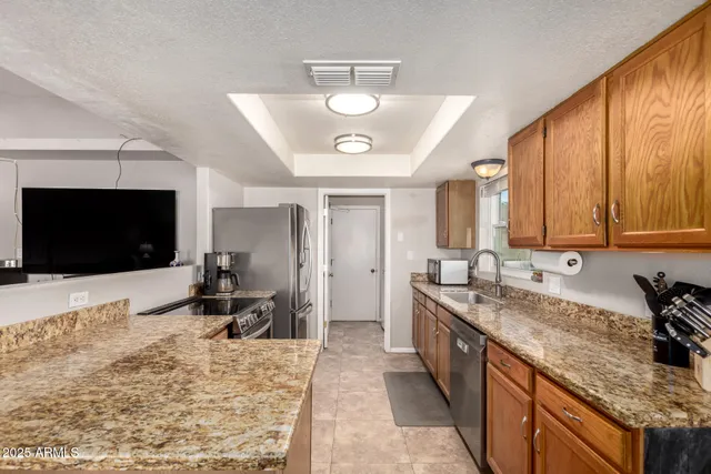 a kitchen with granite countertop cabinets a window and a sink