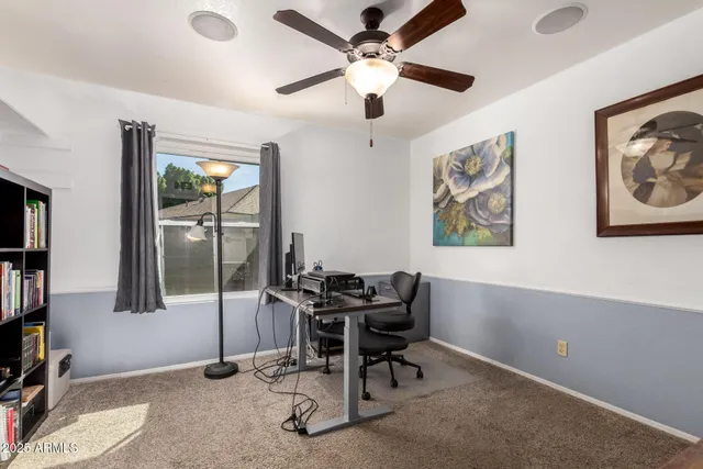 a living room with furniture and a bookshelf