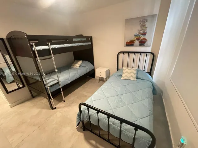 a bedroom with furniture and a window