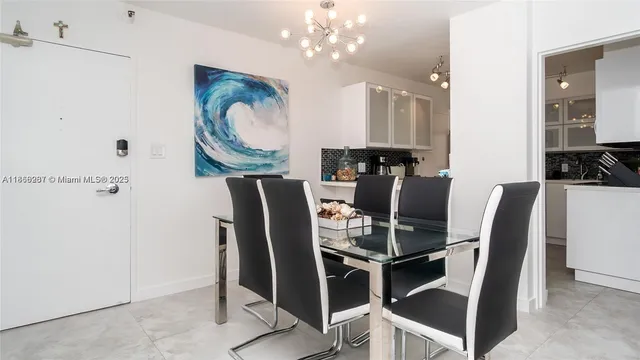 a dining room with furniture and chandelier