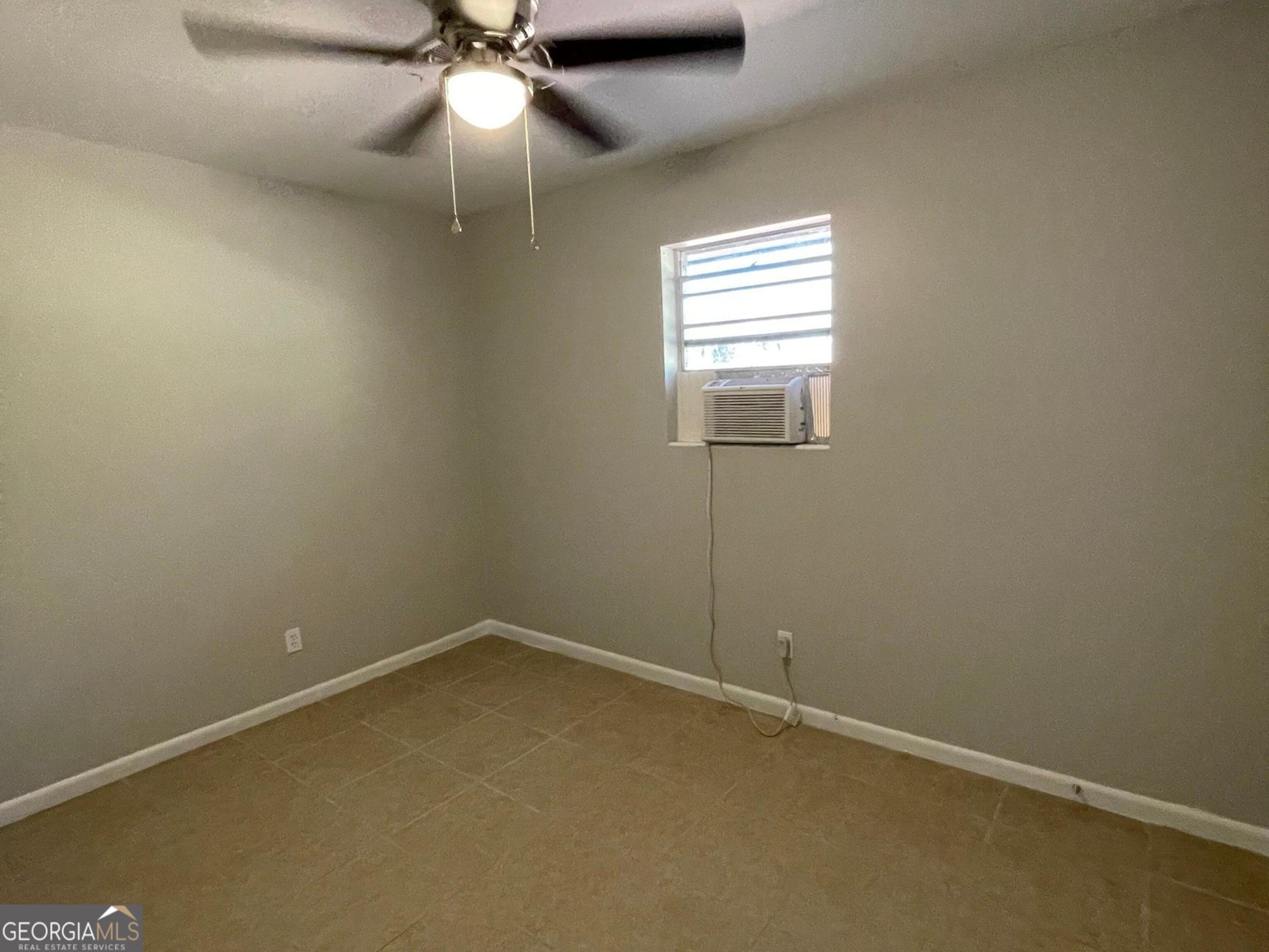 160 Spring Street, Unit B Jonesboro, GA 30236 - Photo 12 of 14 an empty room with windows and fan