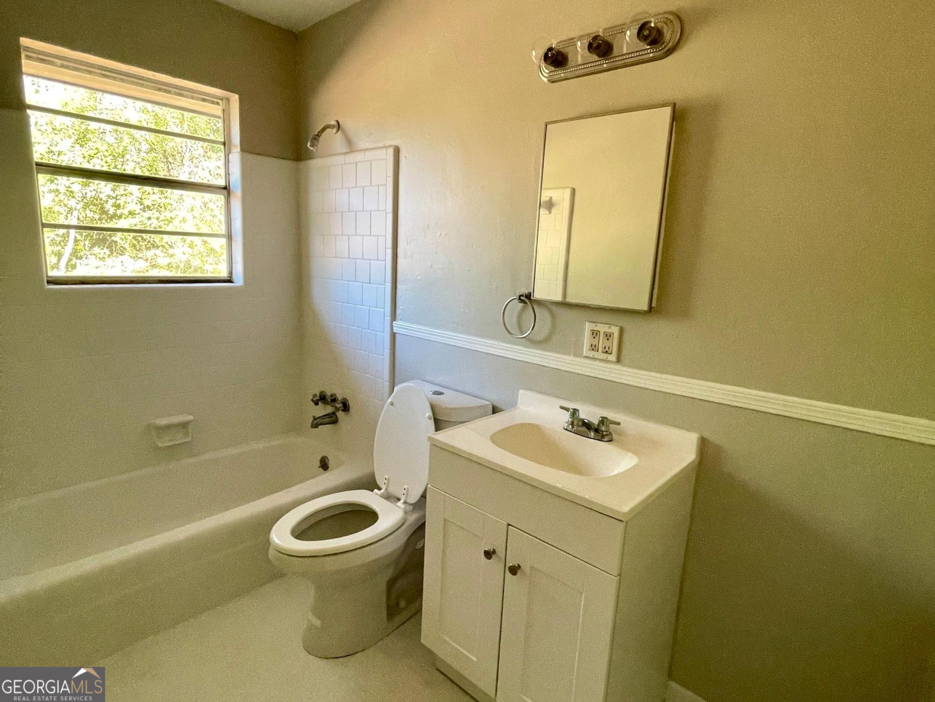 160 Spring Street, Unit B Jonesboro, GA 30236 - Photo 13 of 14 a bathroom with a sink toilet and a bathtub