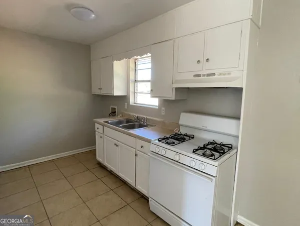 a kitchen with a stove and a refrigerator