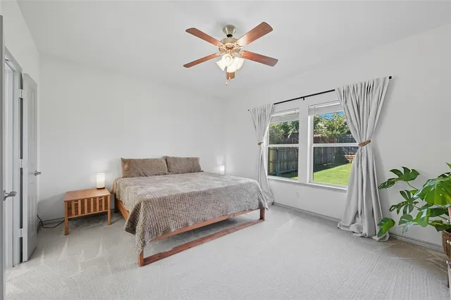 a spacious bedroom with a bed and a window