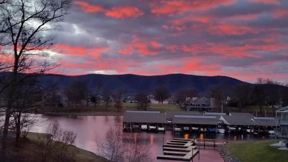 290 Sailors Cove Drive, Unit 405 Moneta, VA 24121 - Photo 15 of 22 a view of a lake with a mountain in the background