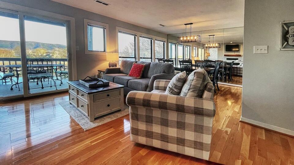 290 Sailors Cove Drive, Unit 405 Moneta, VA 24121 - Photo 3 of 22 a bedroom with furniture and a wooden floor