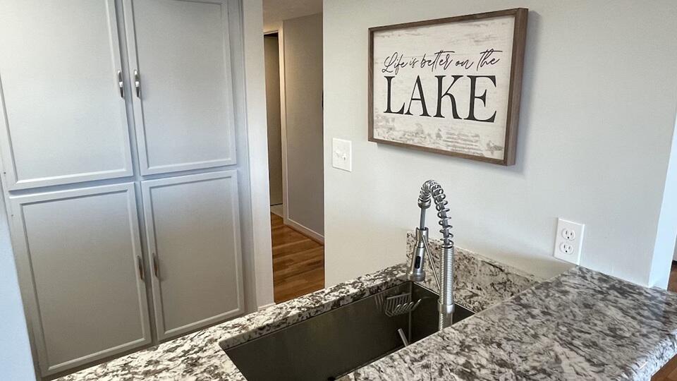 290 Sailors Cove Drive, Unit 405 Moneta, VA 24121 - Photo 6 of 22 a view of a hallway to a bedroom with wooden floor and a bathroom