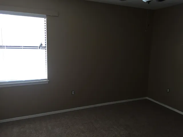 a view of a house with a yard and a tree