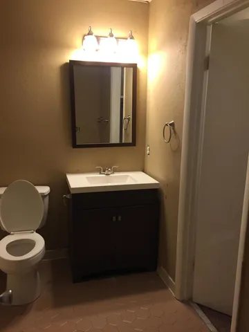 a white toilet and tub next to a bathroom sink