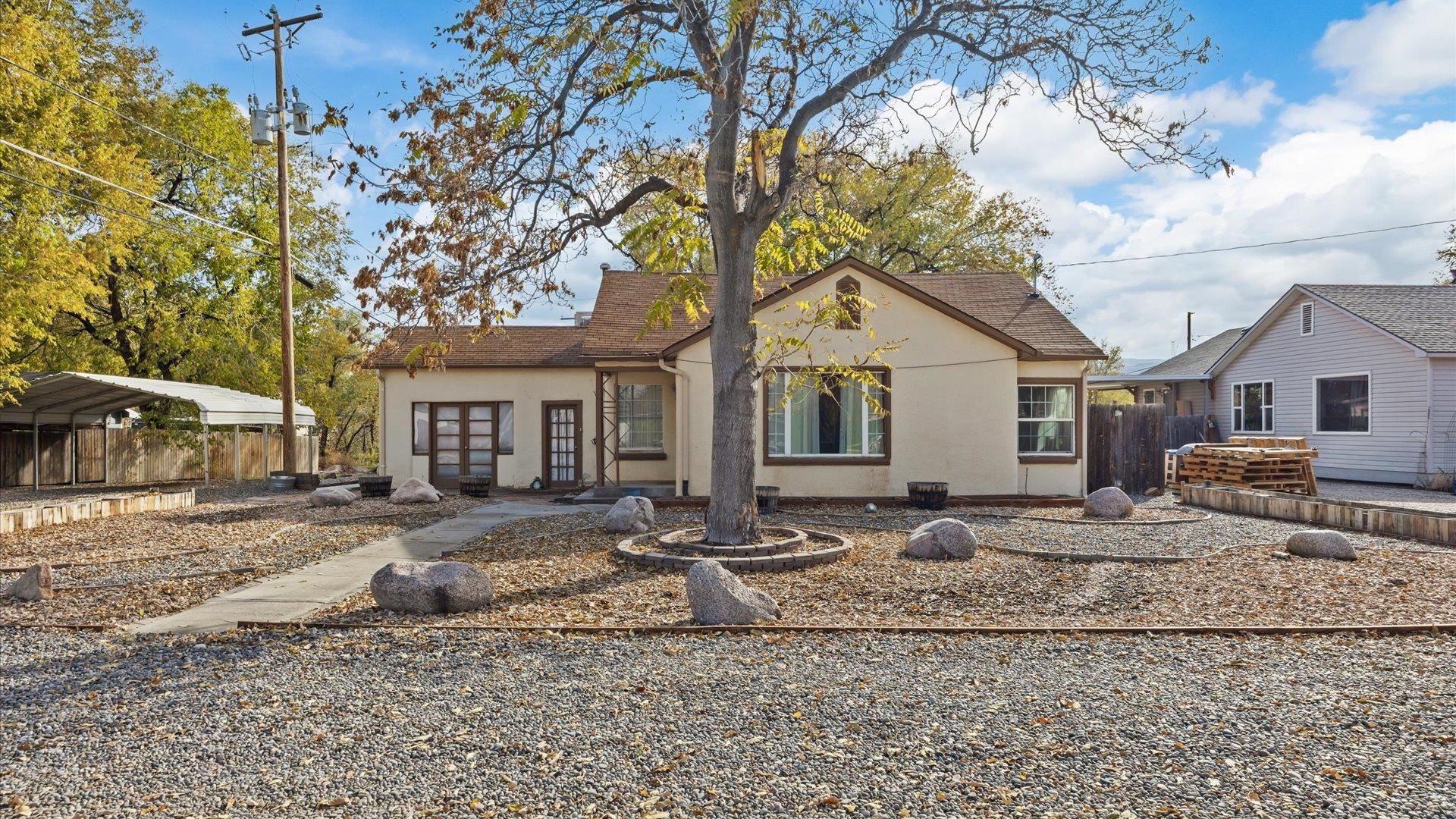 1055 Glenwood Drive Grand Junction, CO 81503 - Photo 1 of 27 a view of a yard with a house and a tree