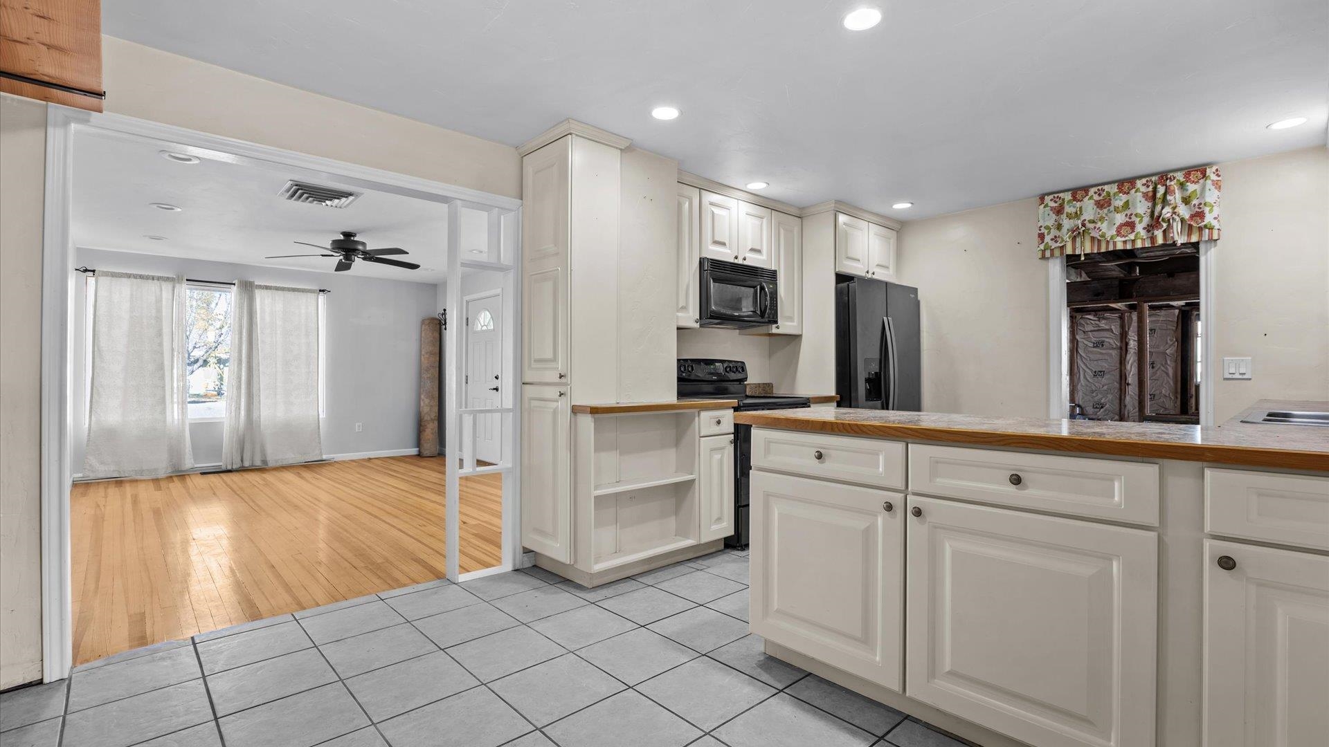 1055 Glenwood Drive Grand Junction, CO 81503 - Photo 11 of 27 a kitchen with white cabinets and white appliances