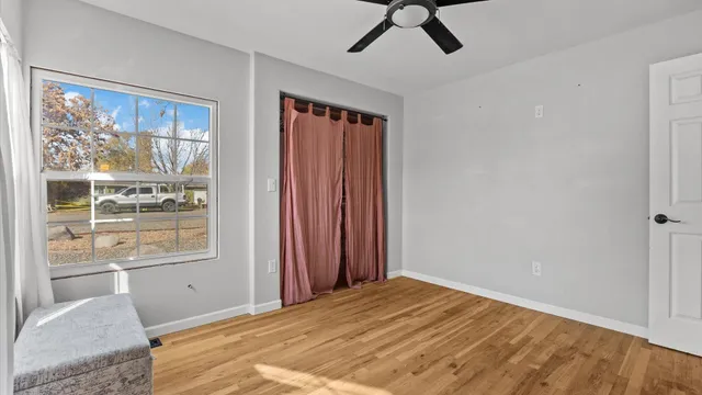 a bedroom with a bed and wooden floor