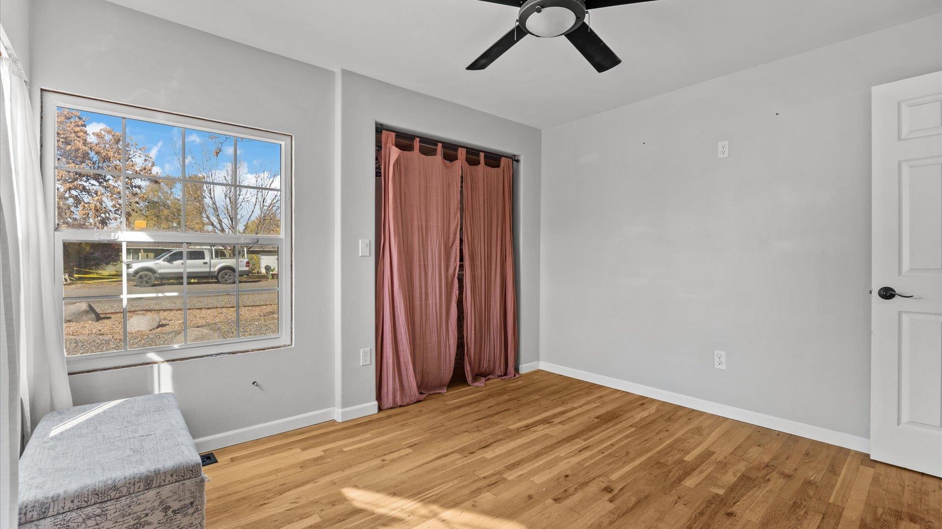 1055 Glenwood Drive Grand Junction, CO 81503 - Photo 14 of 27 a bedroom with a bed and wooden floor