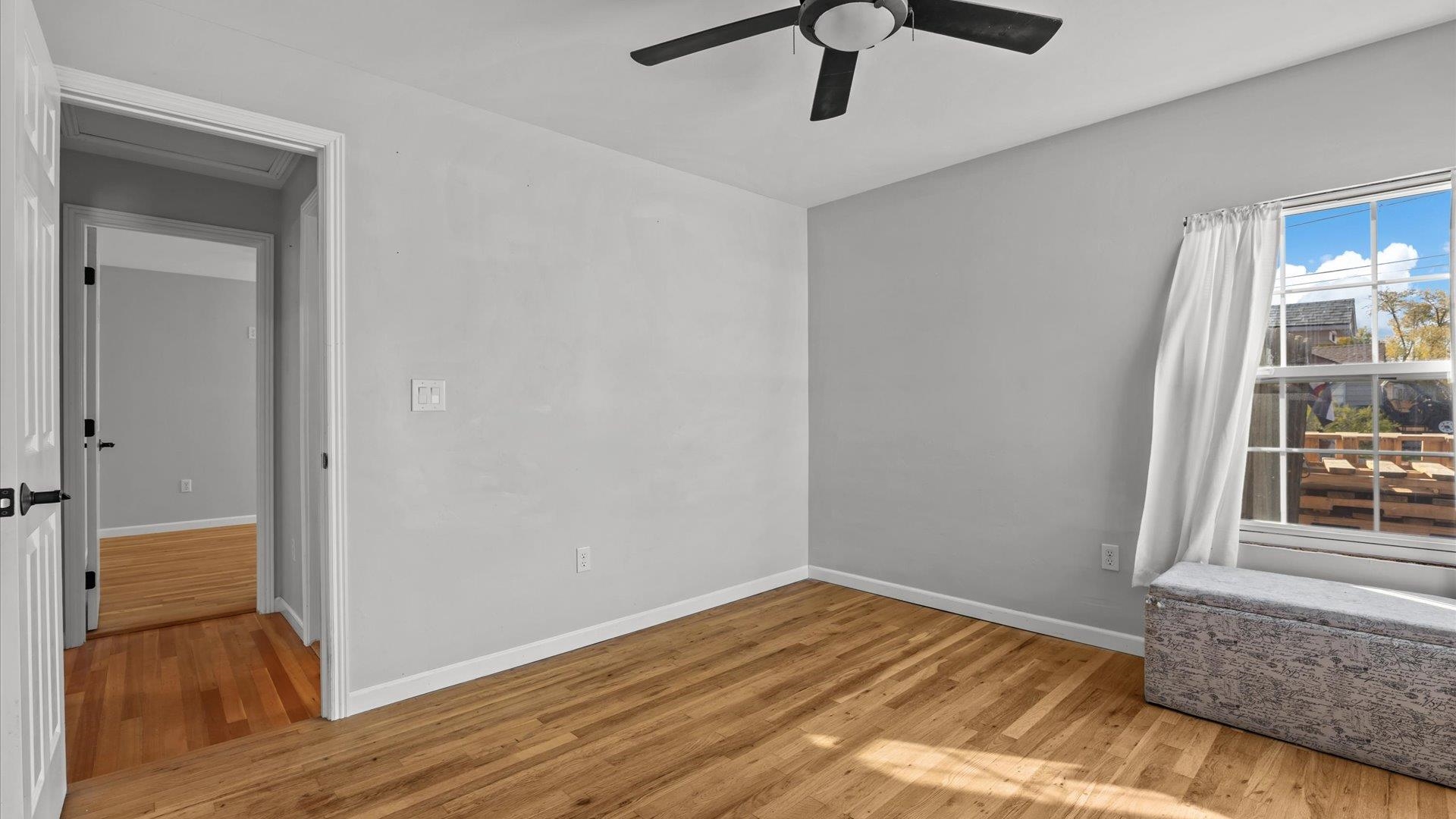 1055 Glenwood Drive Grand Junction, CO 81503 - Photo 15 of 27 a view of empty room with wooden floor and fan