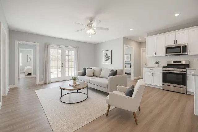 a living room with furniture and a wooden floor