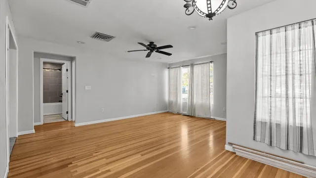 a view of a livingroom with a window and a ceiling fan