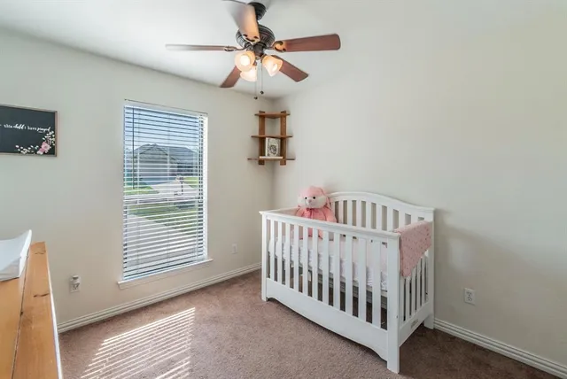 a bedroom with a white bed and a window