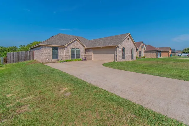 a view of a house with a yard and sitting area