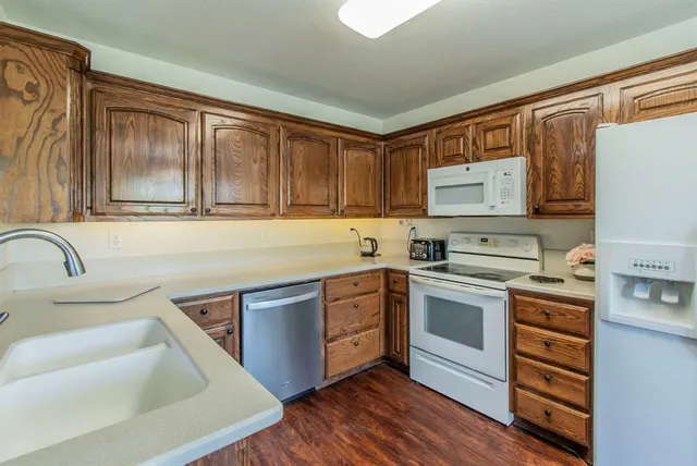 a kitchen with a stove a sink and a refrigerator