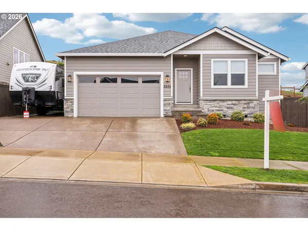a front view of a house with a yard and garage