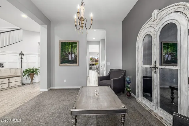 a view of a dining room with furniture a chandelier and wooden floor