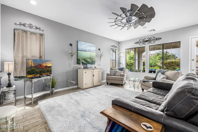 a spacious bedroom with a bed and a flat screen tv