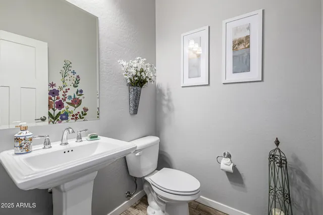 a bedroom with a bed a dresser and a flat screen tv