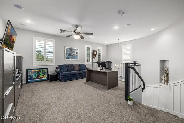 a view of a workspace with furniture and a window
