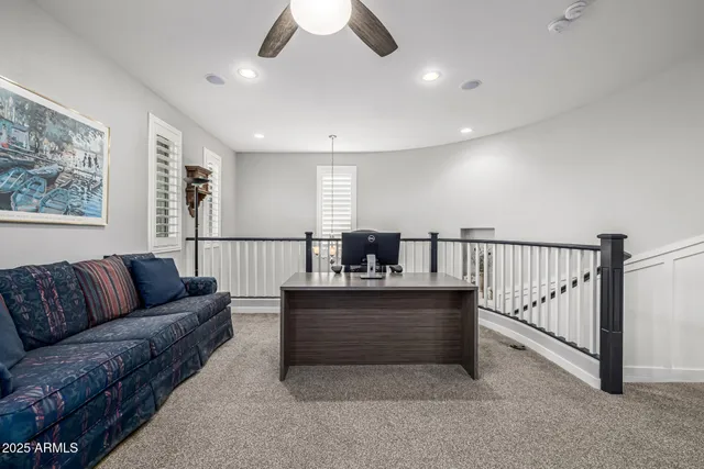 a view of a workspace with furniture and a window