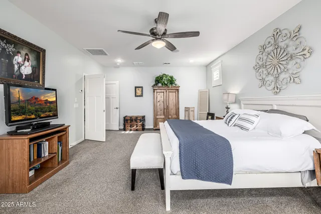 a bedroom with a bed a desk and chair