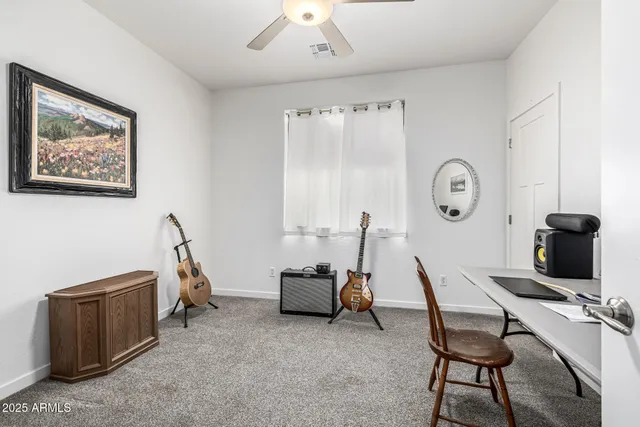 a view of a lake with table and chairs and potted plants