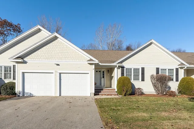 a view of a house with a yard and garage