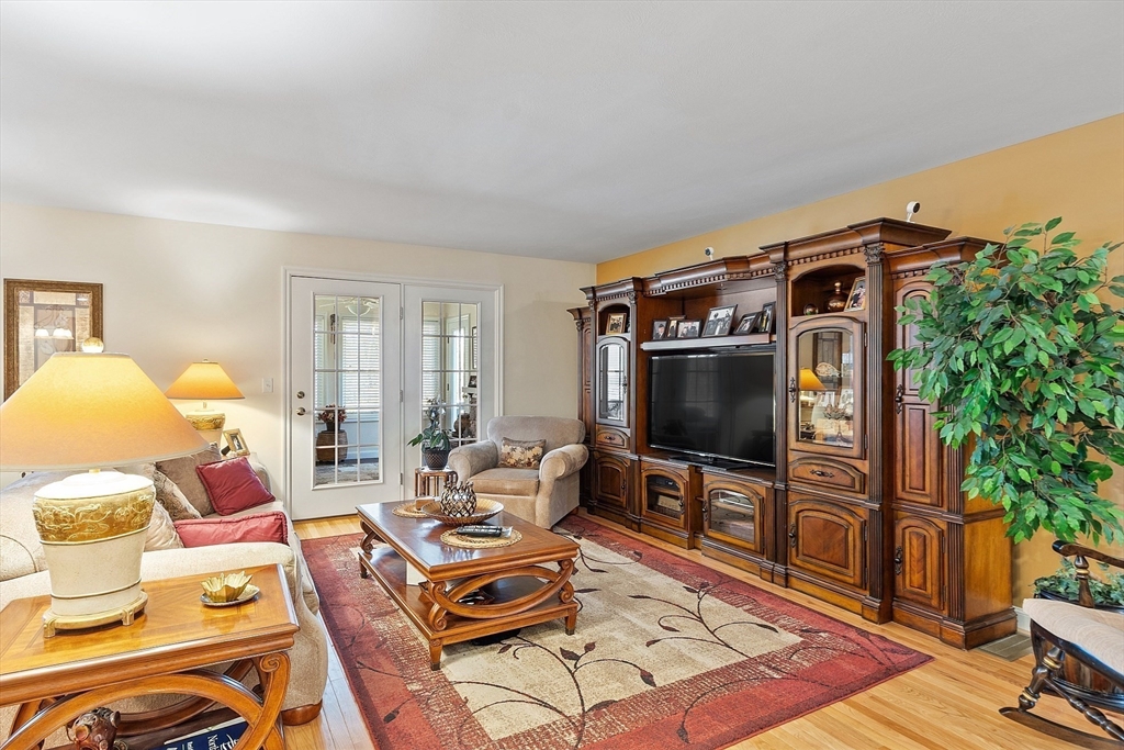 27 Russell Farm Drive, Unit 27 Methuen, MA 01844 - Photo 11 of 39 a living room with furniture and a flat screen tv