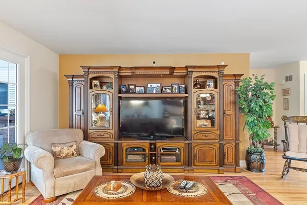 a living room with furniture a flat screen tv and a fireplace