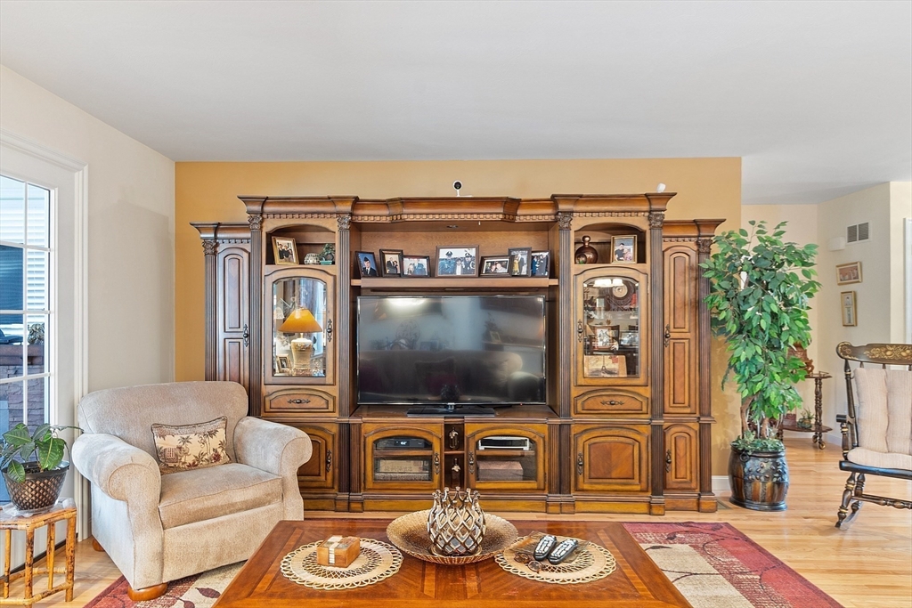 27 Russell Farm Drive, Unit 27 Methuen, MA 01844 - Photo 12 of 39 a living room with furniture a flat screen tv and a fireplace