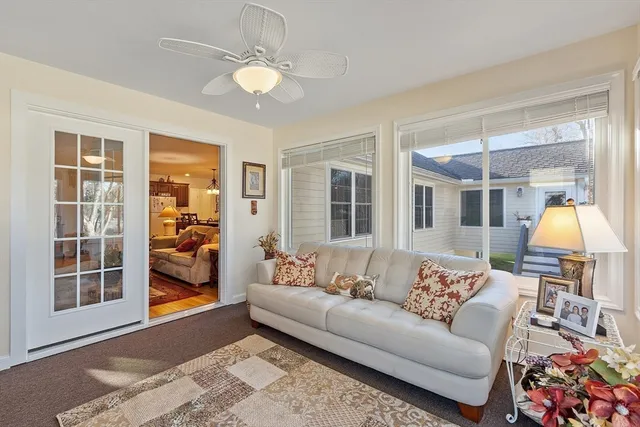 a living room with furniture and a chandelier