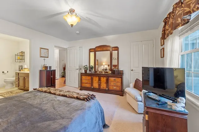 a bedroom with furniture and a flat screen tv