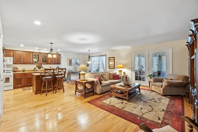 a living room with lots of furniture and kitchen view