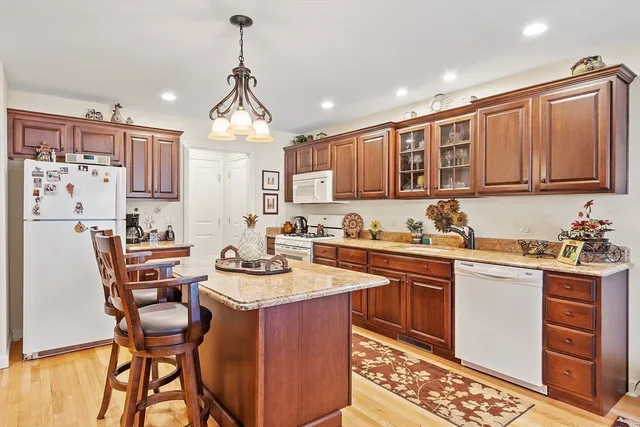 a kitchen with stainless steel appliances kitchen island granite countertop a sink and cabinets