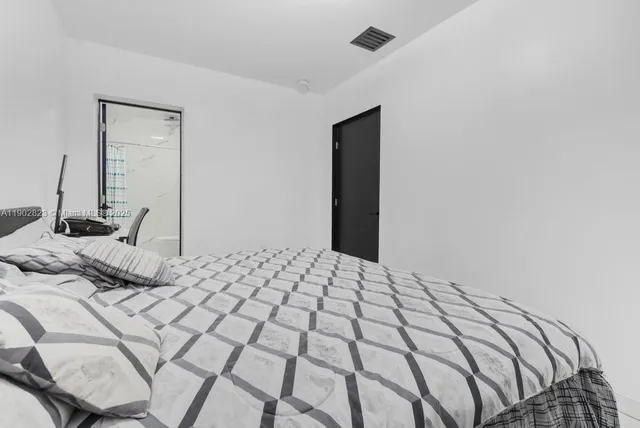 a bedroom with a bed and a mirror