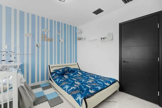 a bedroom with a bed and curtain