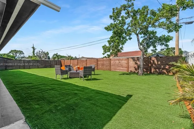 a view of yard with swimming pool and green space