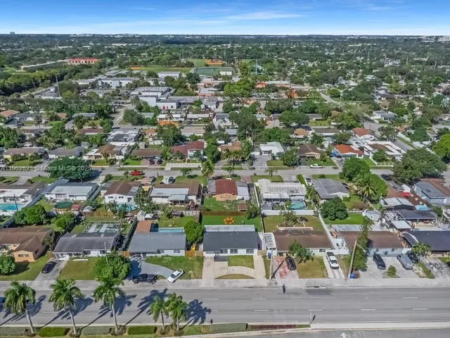 an aerial view of residential houses with city view