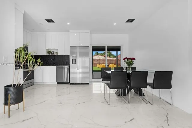 a view of kitchen with dining area and stainless steel appliances