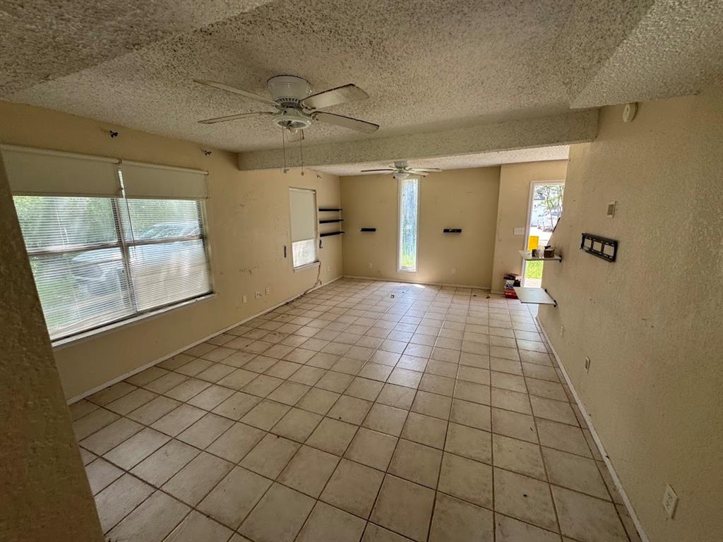 6133 Inca Drive Mabank, TX 75156 - Photo 4 of 10 en empty room with windows and chandelier