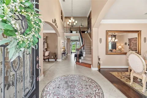 a living room with furniture and a chandelier