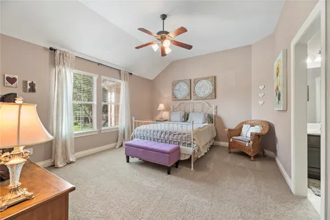 a spacious bedroom with bed and a large window