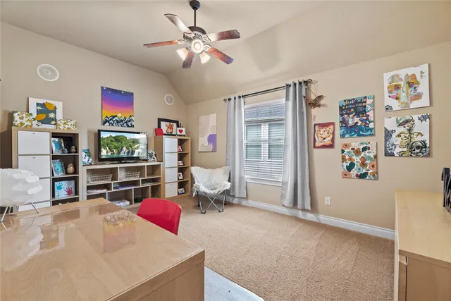 a living room with furniture and a book shelf