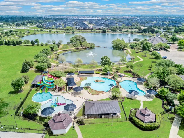 a aerial view of residential house with outdoor space and lake view